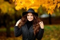Young woman with autumn leaves in hand and fall yellow maple gar Royalty Free Stock Photo