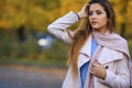 Young woman with autumn leaves in hand and fall yellow maple garden background. Royalty Free Stock Photo