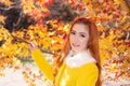 Young woman with autumn leaves in maple garden. Royalty Free Stock Photo