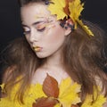 Young woman with autumn make up and leaves on head Royalty Free Stock Photo