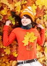 Young woman in autumn orange leaves. Royalty Free Stock Photo