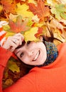 Young woman in autumn orange leaves. Royalty Free Stock Photo