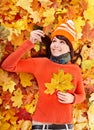 Young woman in autumn orange leaves. Royalty Free Stock Photo