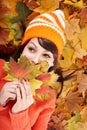 Young woman in autumn orange leaves. Royalty Free Stock Photo