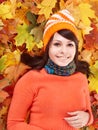 Young woman in autumn orange leaves. Royalty Free Stock Photo