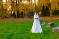 Young woman in a autumn park. Lady with a leafs Royalty Free Stock Photo