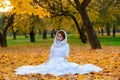 Young woman in a autumn park. Lady with a leafs Royalty Free Stock Photo