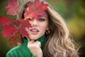 Young woman in autumn park. Warm sunny weather. Fall concept. Hello autumn. Happy woman with autumn yellow leaves Royalty Free Stock Photo
