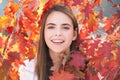 Young woman in autumn park. Warm sunny weather. Fall concept. Hello autumn. Happy woman with autumn yellow leaves Royalty Free Stock Photo