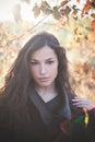 Young woman autumn portrait in warm clothes outdoor sun flare