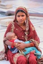 Young woman with a baby sitting in Jama Masjid, Delhi, India Royalty Free Stock Photo