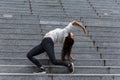 Young Woman Doing Back Stand on Marble Steps