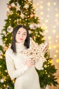 Young woman on the background of the Christmas tree close-up. Woman with fir branches in a knitted dress Royalty Free Stock Photo