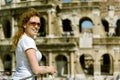 Young woman on the background of the Colosseum in Rome Royalty Free Stock Photo