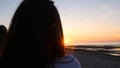 A young woman on the background of the sunset the sun on the seashore does exercises exercised by running, stretching and slumping Royalty Free Stock Photo