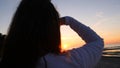 A young woman on the background of the sunset the sun on the seashore does exercises exercised by running, stretching and slumping Royalty Free Stock Photo