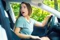 Young woman backing up in a new car