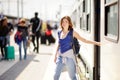 Young woman with backpack getting out of car train Royalty Free Stock Photo