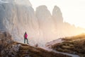 Young woman with backpack on the mountain trail and mountain