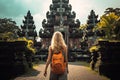 Young woman with backpack standing in front of Pura Besakih temple in Bali, Indonesia, Tourist woman with backpack at vacation