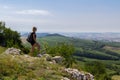 Young woman with backpack standing on lookout in black dress. Palava, Czech republic Royalty Free Stock Photo