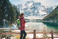 Woman with backpack near lake with azure water in autumn Royalty Free Stock Photo