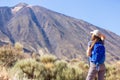 Young woman with backpack standing near Teide Royalty Free Stock Photo