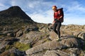 Young woman with backpack trekking on Pico volcano. Royalty Free Stock Photo