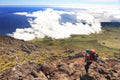 Young woman with backpack trekking on Pico volcano. Royalty Free Stock Photo