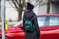 Young woman with backpack waiting to cross street, traffic rules and regulations Royalty Free Stock Photo