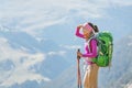 Woman backpacker tourist standing on a top of the mountain ridge Royalty Free Stock Photo