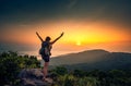 Young hiker standing with arms stretched on top of the Mountain Ban Co Peak, Da Nang Vietnam Royalty Free Stock Photo