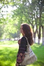 Young woman with bag walking at the summer park Royalty Free Stock Photo