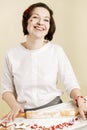 Young woman bakes Christmas cookies for the holiday. Royalty Free Stock Photo