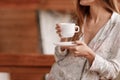 Young woman on the balcony holding a cup of coffee or tea in the morning. Relax time Royalty Free Stock Photo