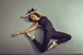 Young woman ballerina lying on the floor without feelings at ballet studio, view from above. Royalty Free Stock Photo