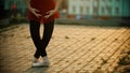 Young woman ballerina standing in the plie pose on the roof - modern buildings on the background