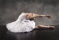 Ballerina in white tutu, leaning back like a swan