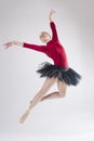 Young woman ballet dancer leaping in a black tutu