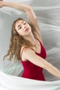 Young woman dancing with green fabric flying in the studio Royalty Free Stock Photo