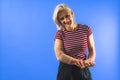 young woman with a bandage on her elbow for support, blue background Royalty Free Stock Photo