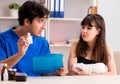 Young woman with bandaged arm visiting male doctor traumotologis Royalty Free Stock Photo