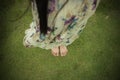 Young woman barefoot walking on the fresh, green grass in sunny summer in the morning. Restful moment. Healthy lifestyle. Brigh Royalty Free Stock Photo