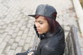 Young woman with baseball cap, urban style.