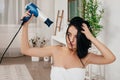 Young woman in bath towel drying hair