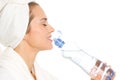 Woman in bathrobe drinking from bottle with water Royalty Free Stock Photo