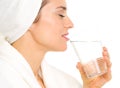 Young woman in bathrobe drinking water Royalty Free Stock Photo