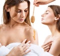 Young woman in bathrobe prepare for honey facial mask.