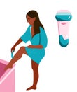 Young woman in bathrobe is shaving her legs with razor. Electronic Depilation. Royalty Free Stock Photo