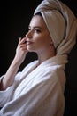 Young woman in a bathrobe and towel on her head, spa and care portrait, clean face Royalty Free Stock Photo